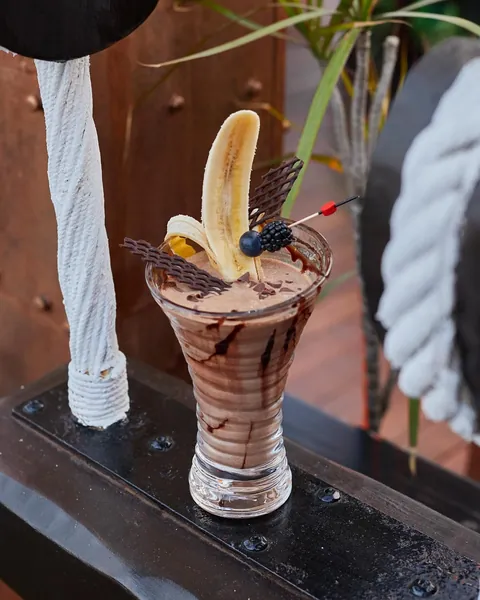 A chocolate and banana cocktail with chocolate lattice shards.