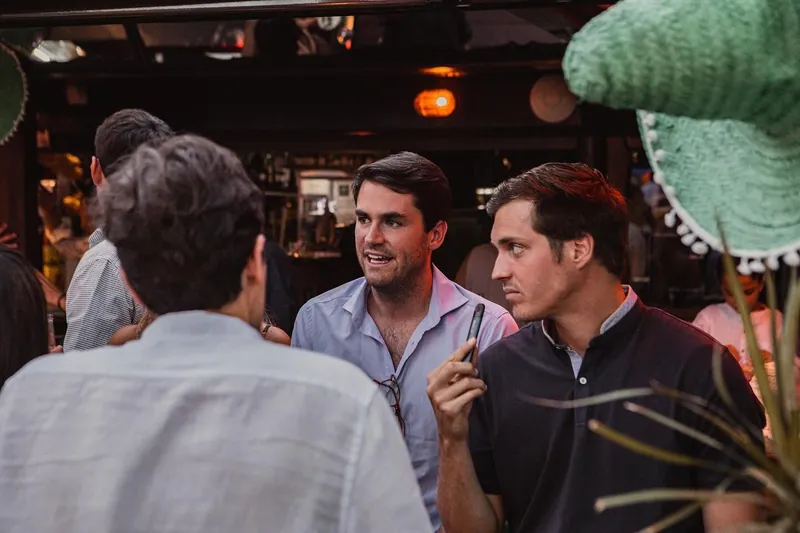 Friends talking at the bar in the evening.